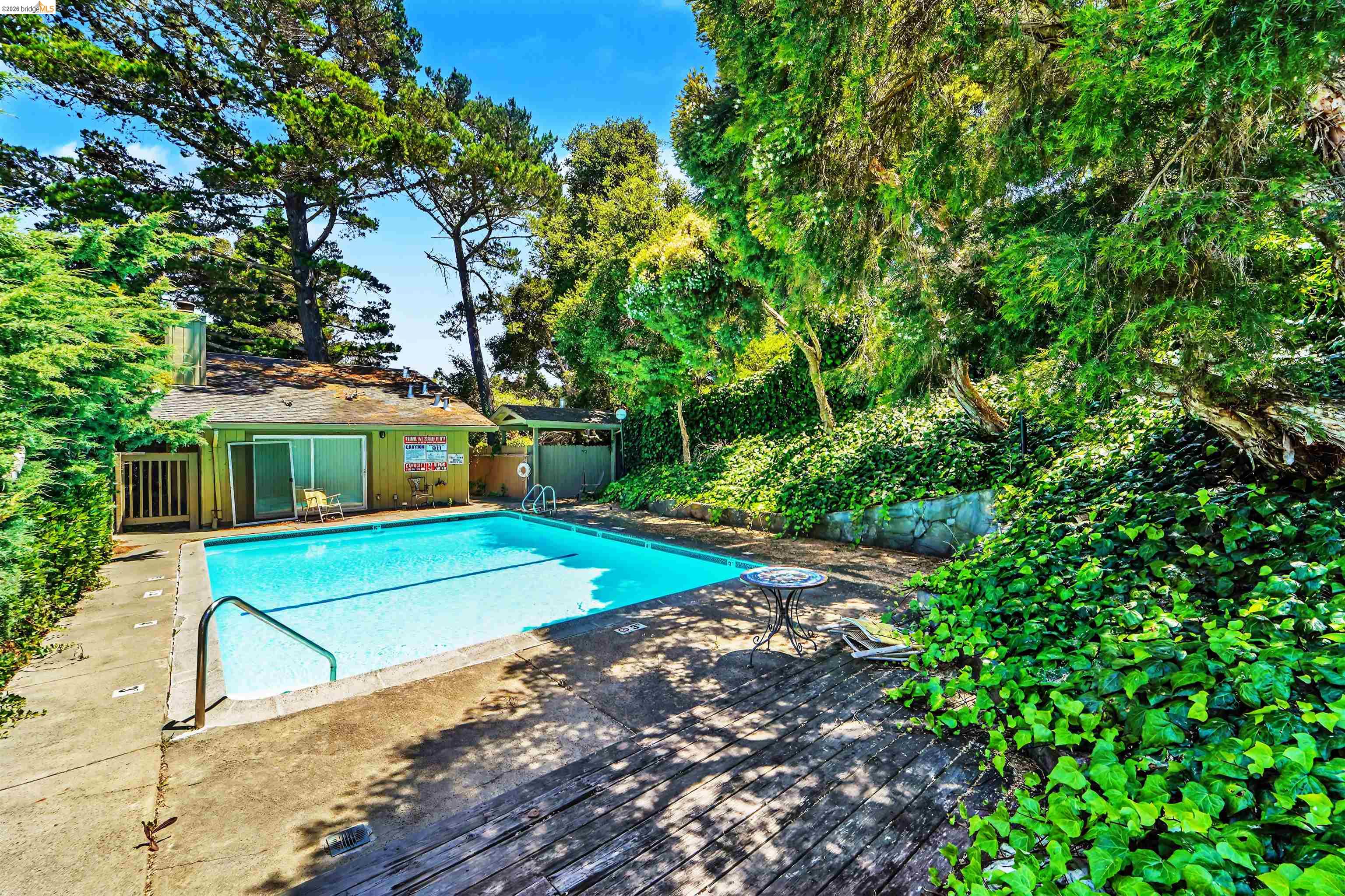 4186 San Pablo Dam Road, Unit A El Sobrante, CA 94803 - Photo 33 of 34 Outdoor swimming pool surrounded by a concrete deck and wood-finish patio
