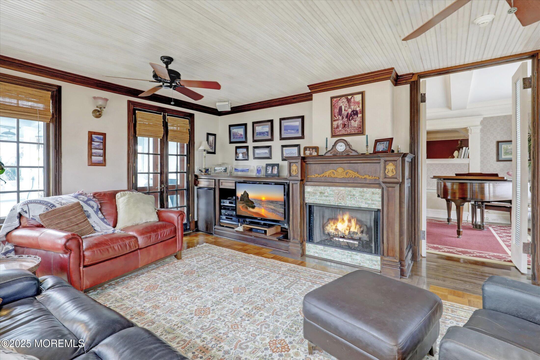 211 Cedar Avenue Allenhurst, NJ 07711 - Photo 14 of 69 a living room with furniture a flat screen tv and a fireplace