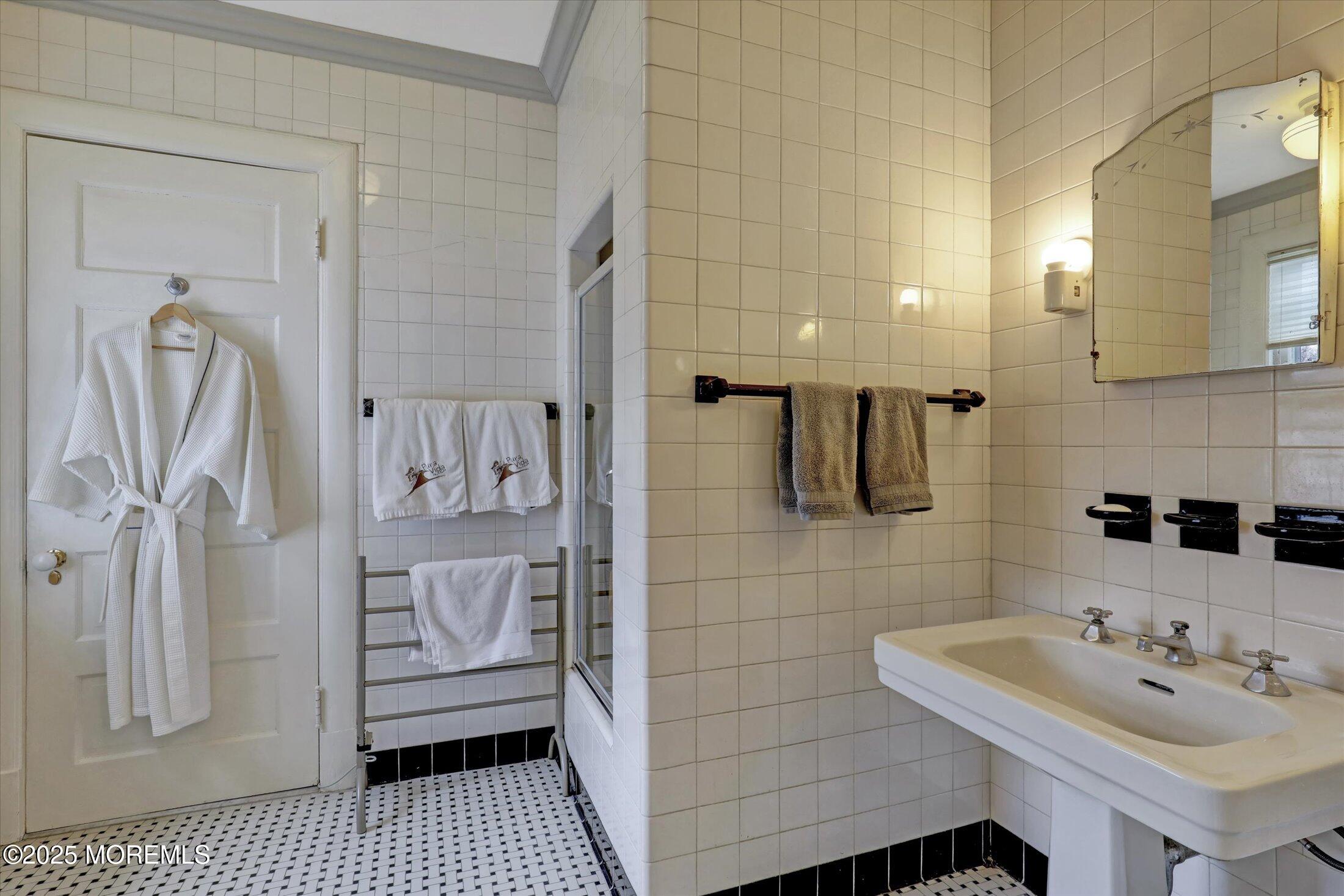 211 Cedar Avenue Allenhurst, NJ 07711 - Photo 27 of 69 a bathroom with a sink a toilet and shower
