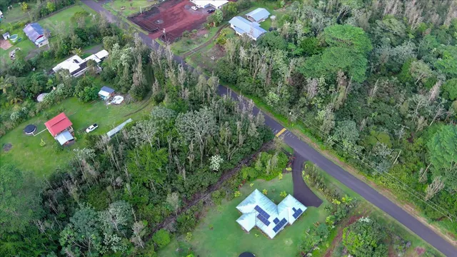 a backyard of a house with lots of green space and flowers