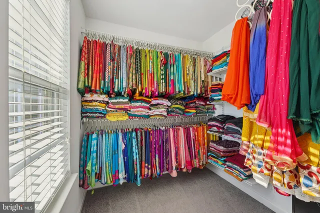 a view of a bedroom with clothes and shoes