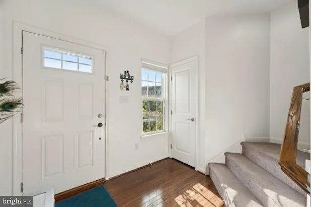 a view of a bedroom with wooden floor and a window