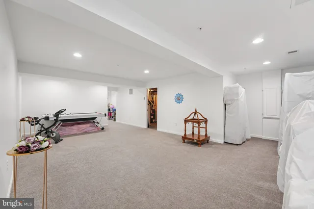 a living room with furniture gym equipment and a chandelier
