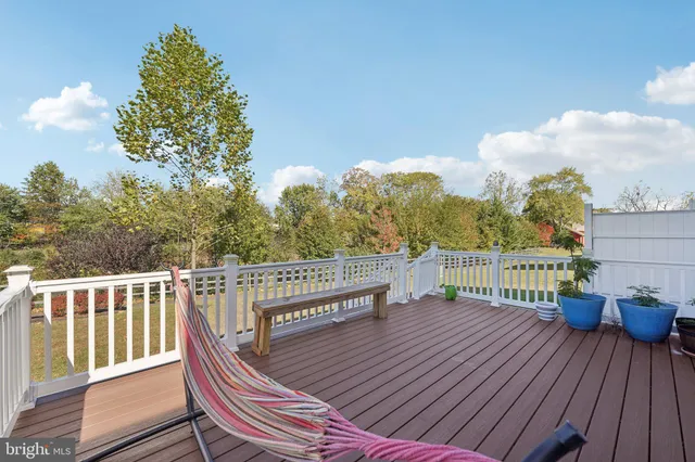 a view of a balcony with wooden floor and outdoor seating