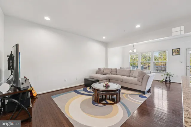 a living room with furniture a rug and a flat screen tv