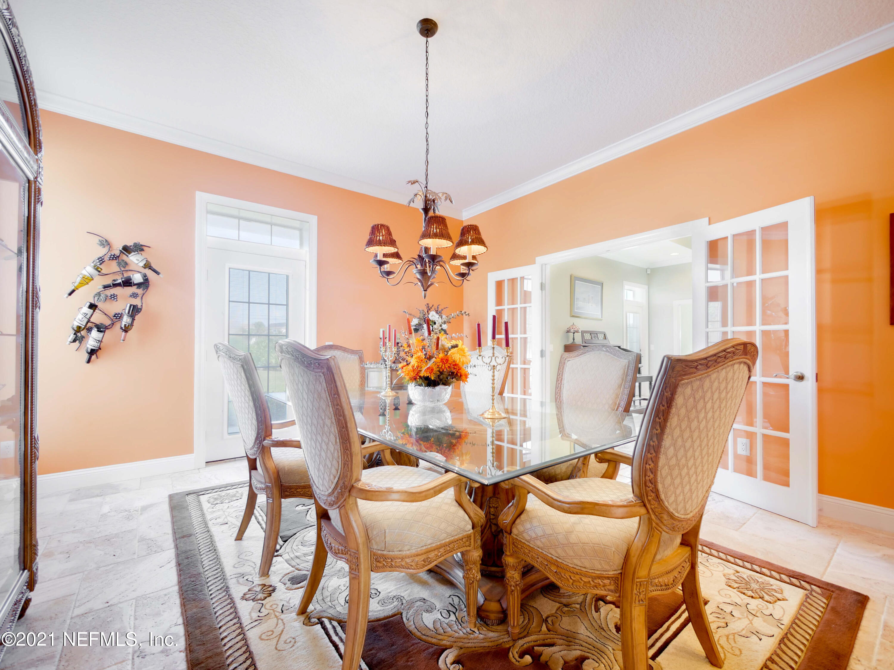 8115 A1A South St. Augustine, FL 32080 - Photo 11 of 50 a dining room with furniture a chandelier and window