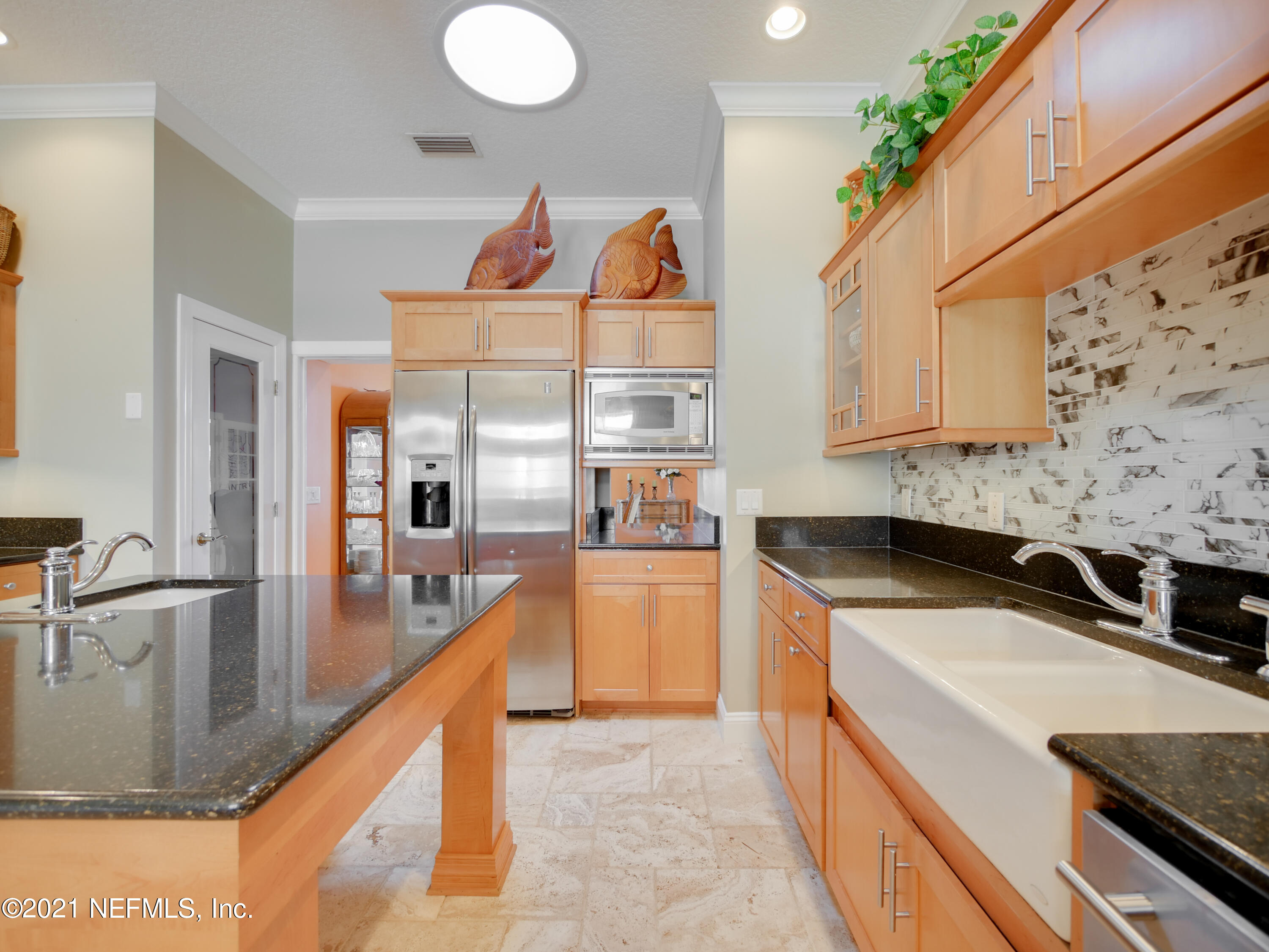 8115 A1A South St. Augustine, FL 32080 - Photo 16 of 50 a kitchen with stainless steel appliances granite countertop a sink a stove and a wooden cabinets