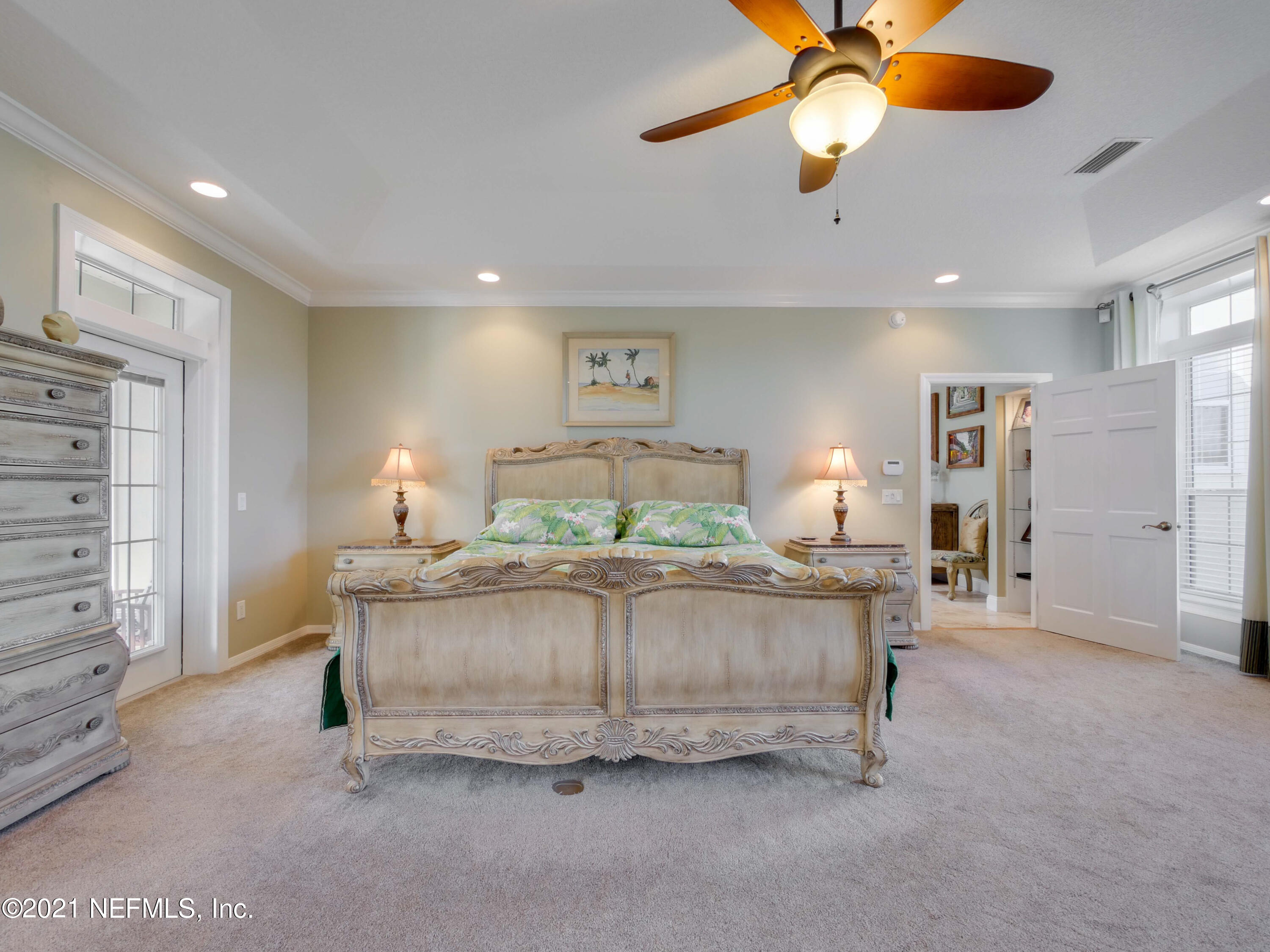 8115 A1A South St. Augustine, FL 32080 - Photo 25 of 50 a spacious bedroom with a bed and a ceiling fan