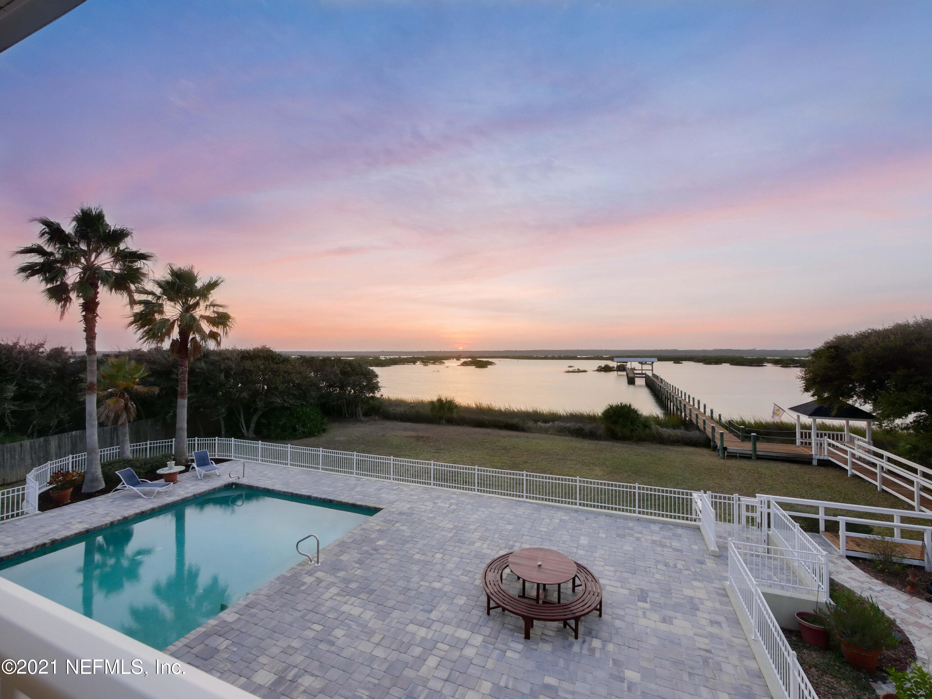8115 A1A South St. Augustine, FL 32080 - Photo 44 of 50 a view of a swimming pool with an outdoor seating and a garden view