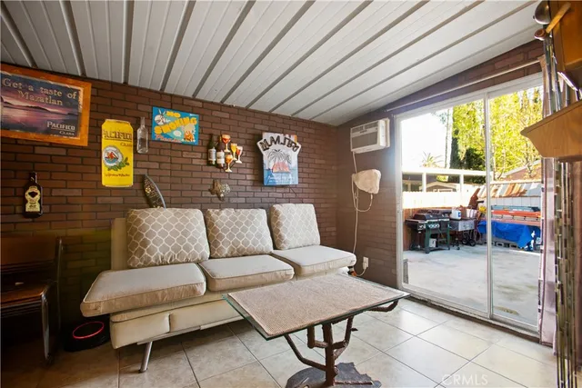 a living room with furniture and a floor to ceiling window