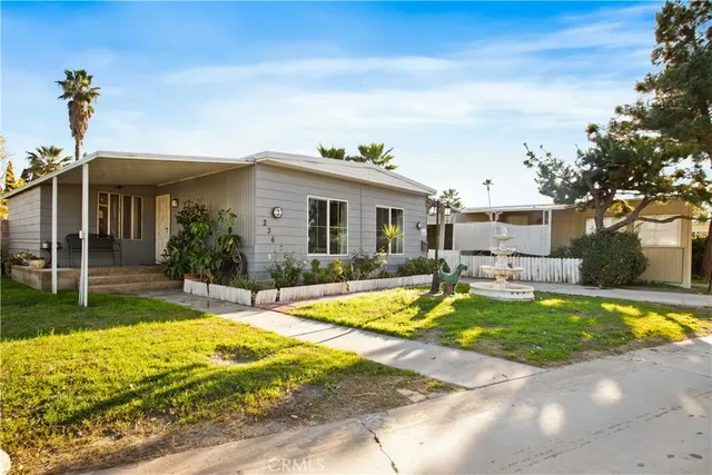a view of a house with swimming pool and a yard