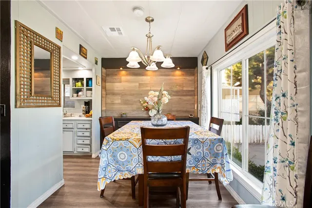 a dining room with furniture a window and wooden floor