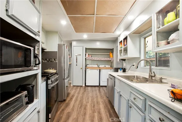 a kitchen with a sink stainless steel appliances and cabinets