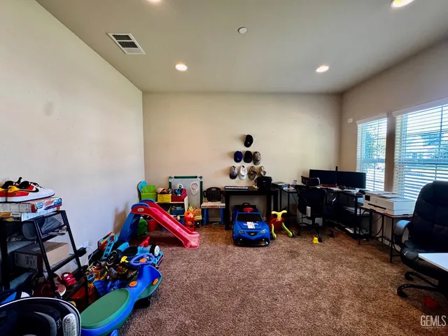 a bedroom with two beds and a chandelier