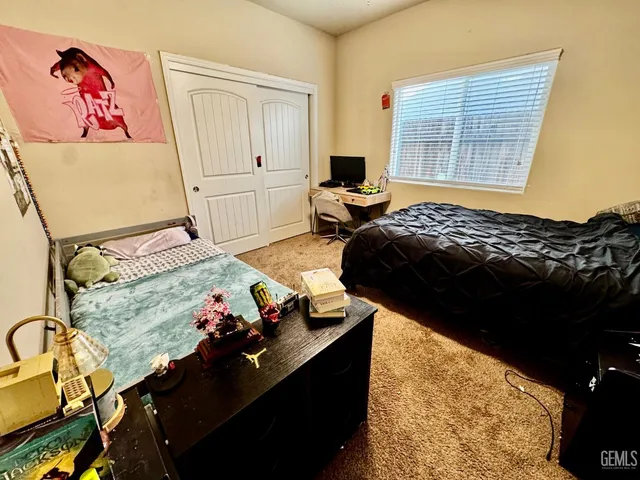 a bedroom with bed and a window