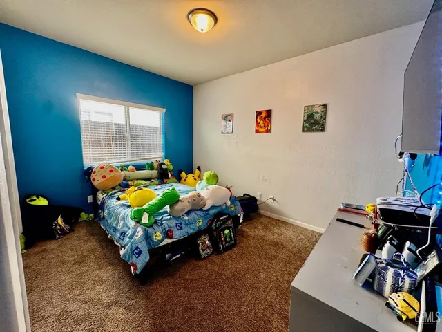 a bathroom with a granite countertop sink a mirror and a shower