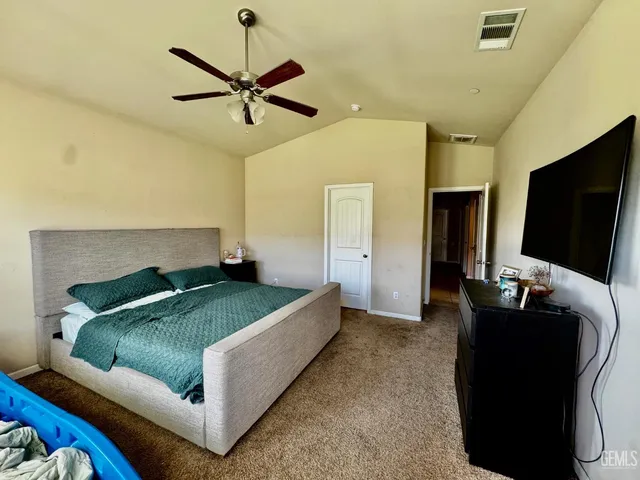 a bathroom with a granite countertop double vanity sink and a mirror