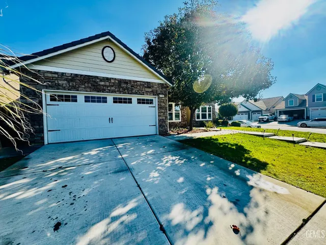 a front view of a house with swimming pool and a yard