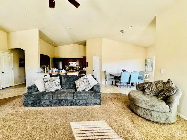 a living room with furniture and a kitchen view