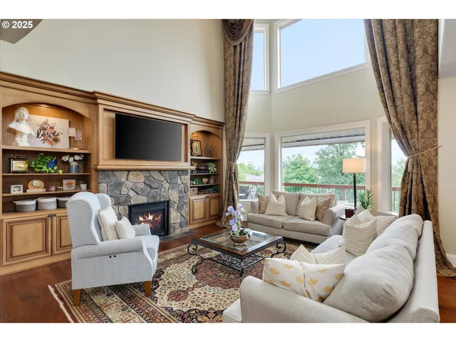 a living room with furniture fireplace and flat screen tv