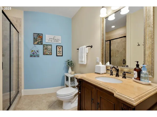 a bathroom with a granite countertop toilet sink and mirror