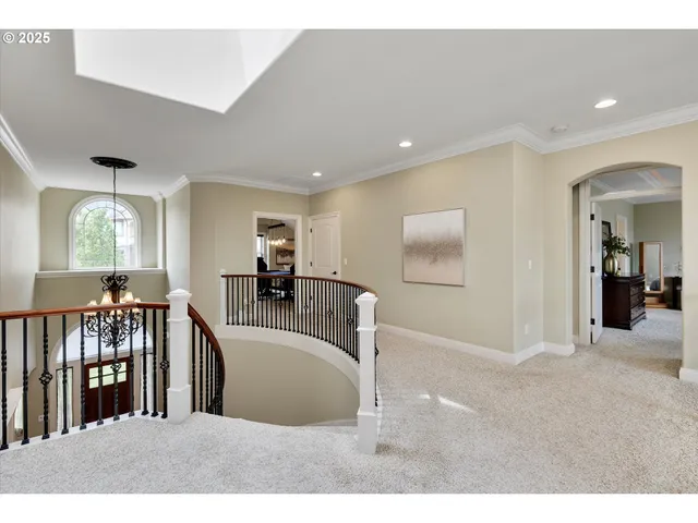 a view of a livingroom with furniture stairs and windows