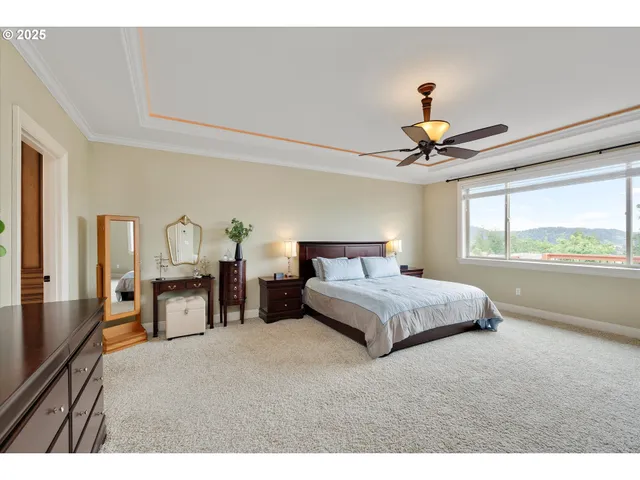 a bedroom with a large bed and a chandelier