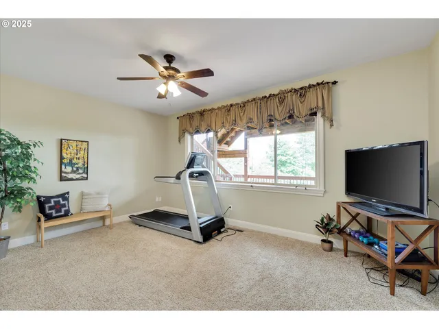 a living room with a flat screen tv and a window