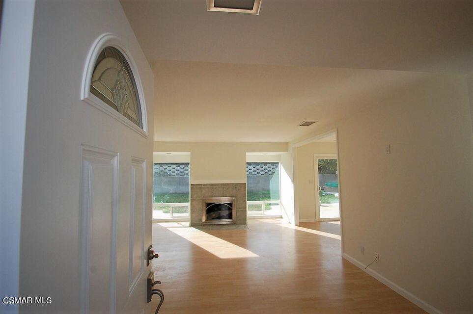 a view of an empty room and fire place