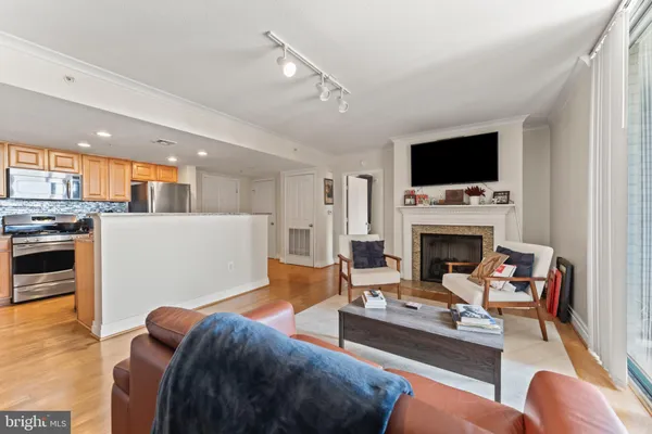 a living room with furniture a flat screen tv and a fireplace
