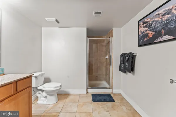 a bathroom with a toilet and a shower
