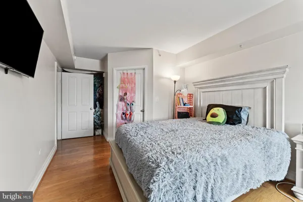 a bedroom with a bed and a flat screen tv