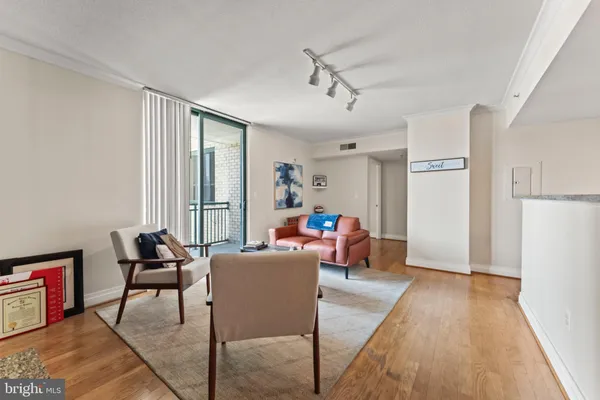 a living room with furniture and a wooden floor