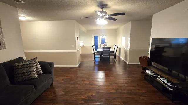 a view of a dining room with furniture and wooden floor
