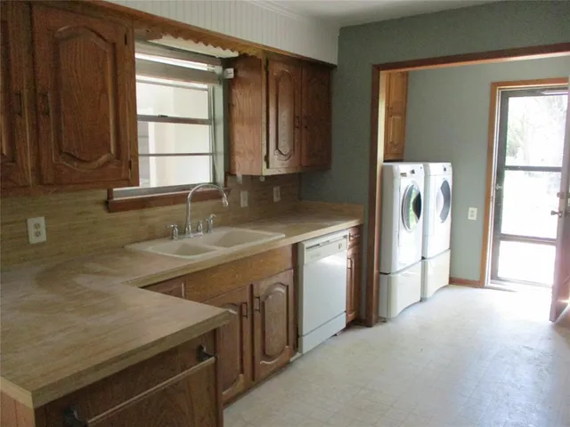 a kitchen with a sink cabinets and a refrigerator