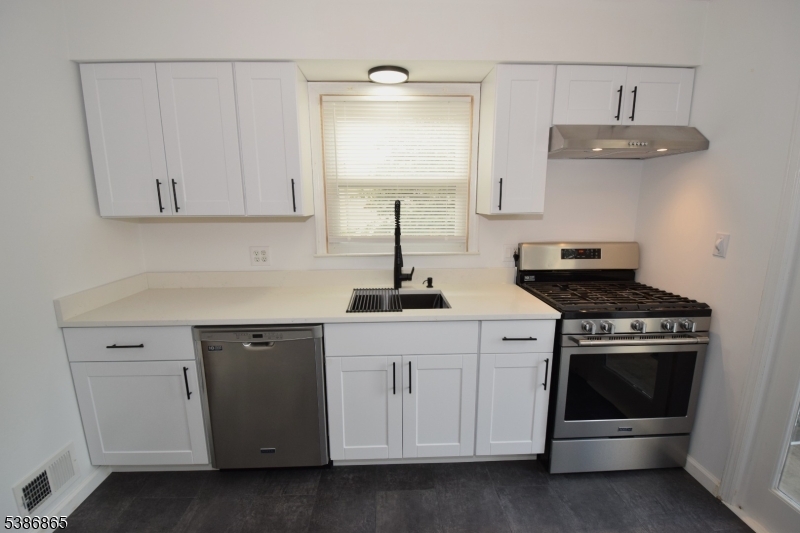 40 Glaser Avenue Raritan, NJ 08869 - Photo 3 of 28 a kitchen with white cabinets and appliances
