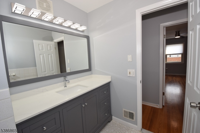 40 Glaser Avenue Raritan, NJ 08869 - Photo 10 of 28 a bathroom with a double vanity sink and a mirror