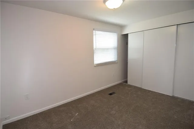an empty room with a empty space and windows