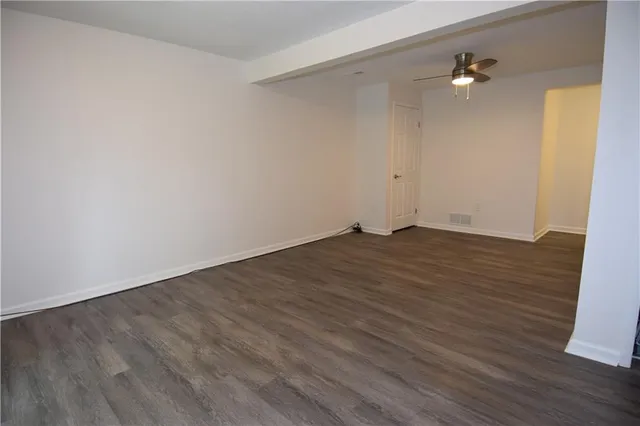 a backyard of a house with barbeque oven and swing