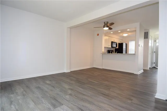a view of a kitchen with a sink and a refrigerator
