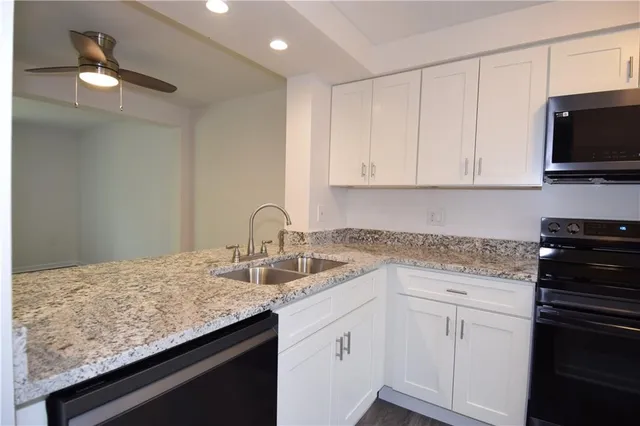 a kitchen with appliances cabinets and a counter top space