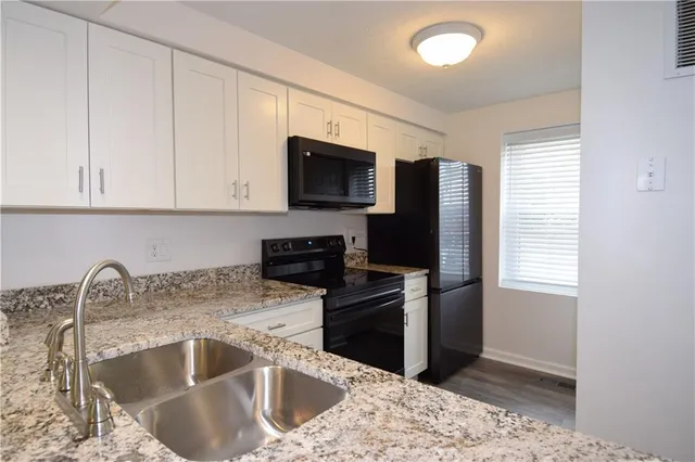 a kitchen with a sink microwave and refrigerator
