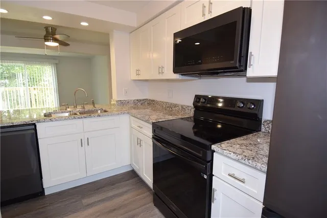a kitchen with a sink stove and microwave