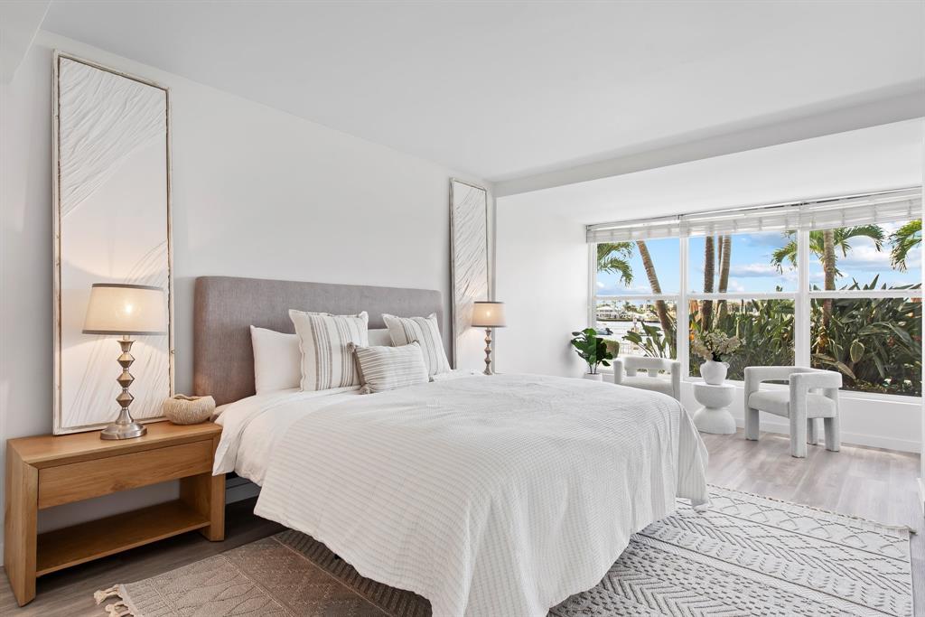 215 North Birch Road, Unit 1C Fort Lauderdale, FL 33304 - Photo 12 of 21 a bedroom with a bed and a large window