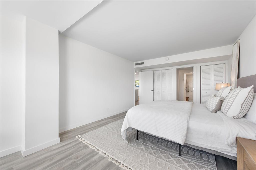 215 North Birch Road, Unit 1C Fort Lauderdale, FL 33304 - Photo 14 of 21 a bedroom with a bed and a night stand