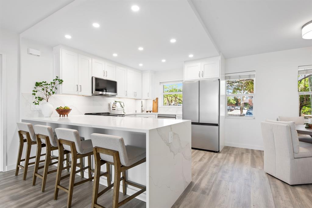 215 North Birch Road, Unit 1C Fort Lauderdale, FL 33304 - Photo 2 of 21 a kitchen with a table and chairs in it
