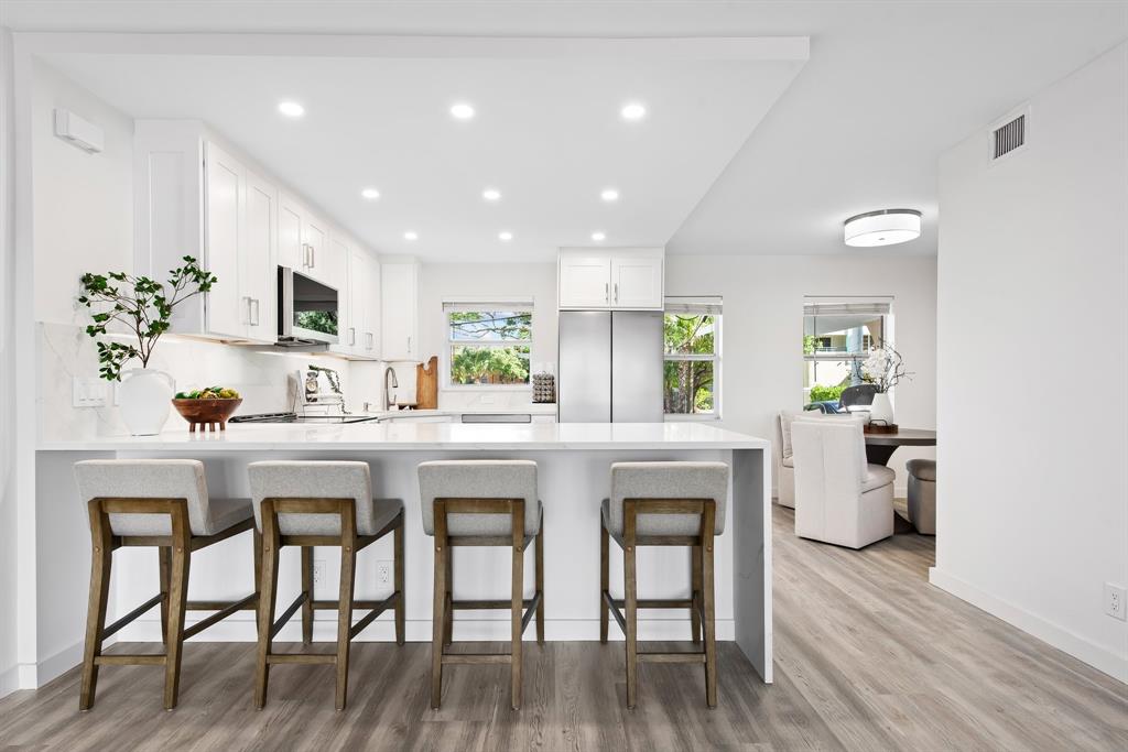 215 North Birch Road, Unit 1C Fort Lauderdale, FL 33304 - Photo 3 of 21 a kitchen with a table and chairs in it