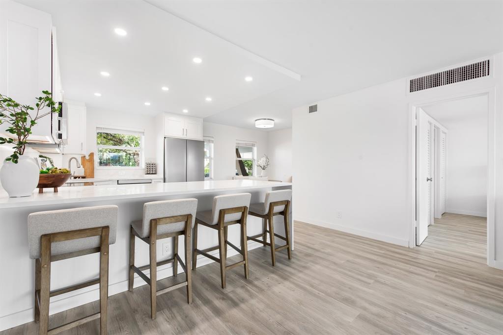 215 North Birch Road, Unit 1C Fort Lauderdale, FL 33304 - Photo 7 of 21 a kitchen with a table and chairs in it