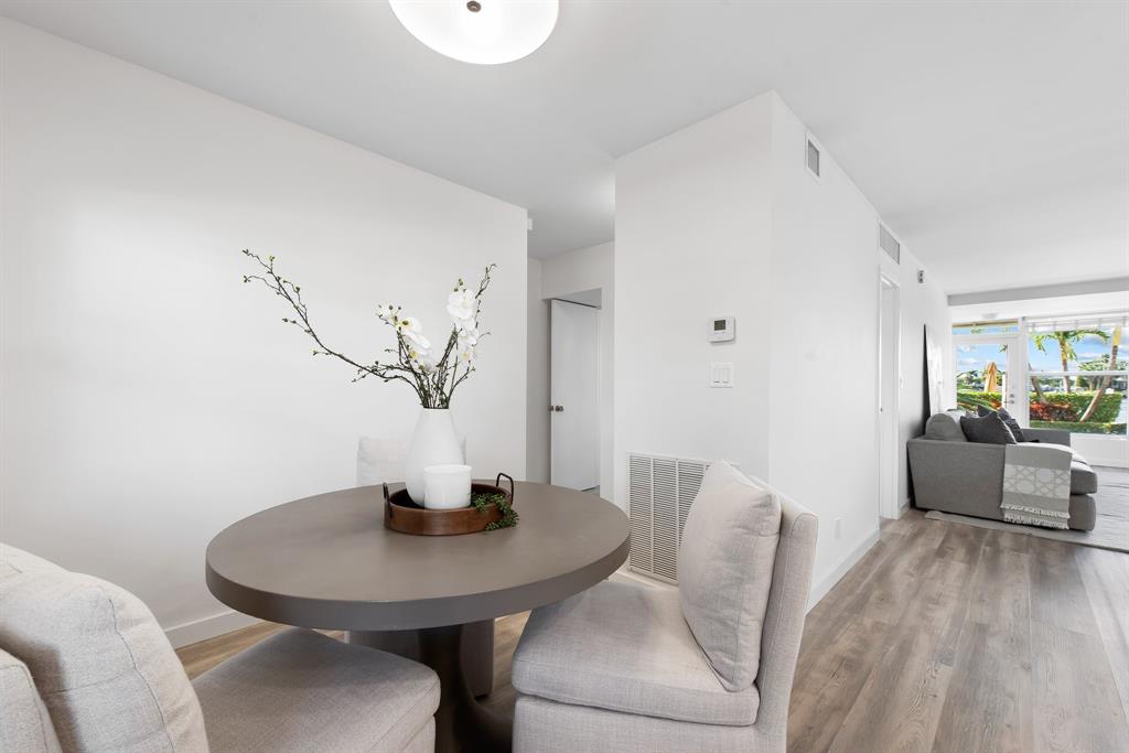215 North Birch Road, Unit 1C Fort Lauderdale, FL 33304 - Photo 10 of 21 a view of a dining room with furniture and wooden floor