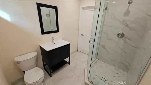 a bathroom with a toilet sink and shower